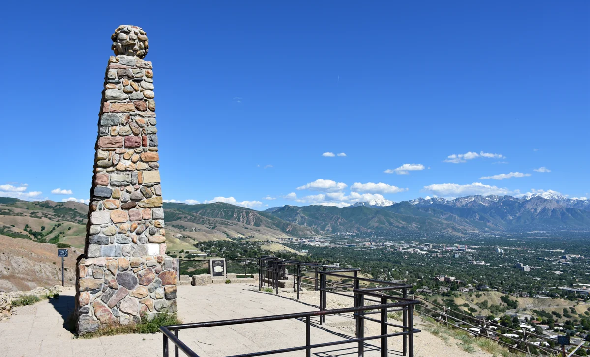 The stone monument on Ensign Peak with the Wasatch Mountains beyond