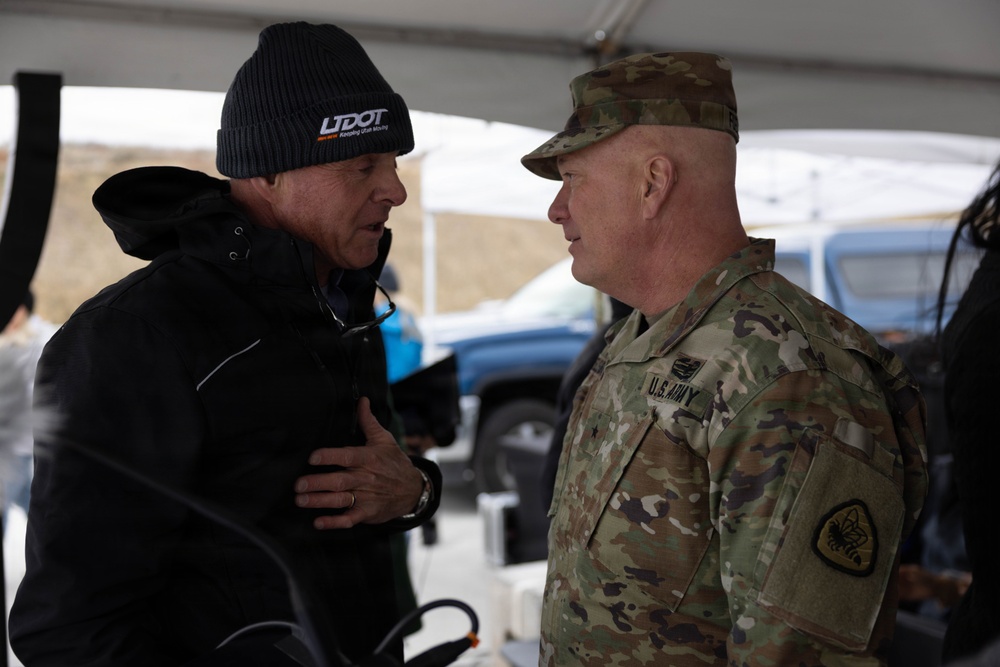 Carlos Braceras, left, wearing a UDOT knit cap, speaks with Brigadier General Shawn Fuellenbach.