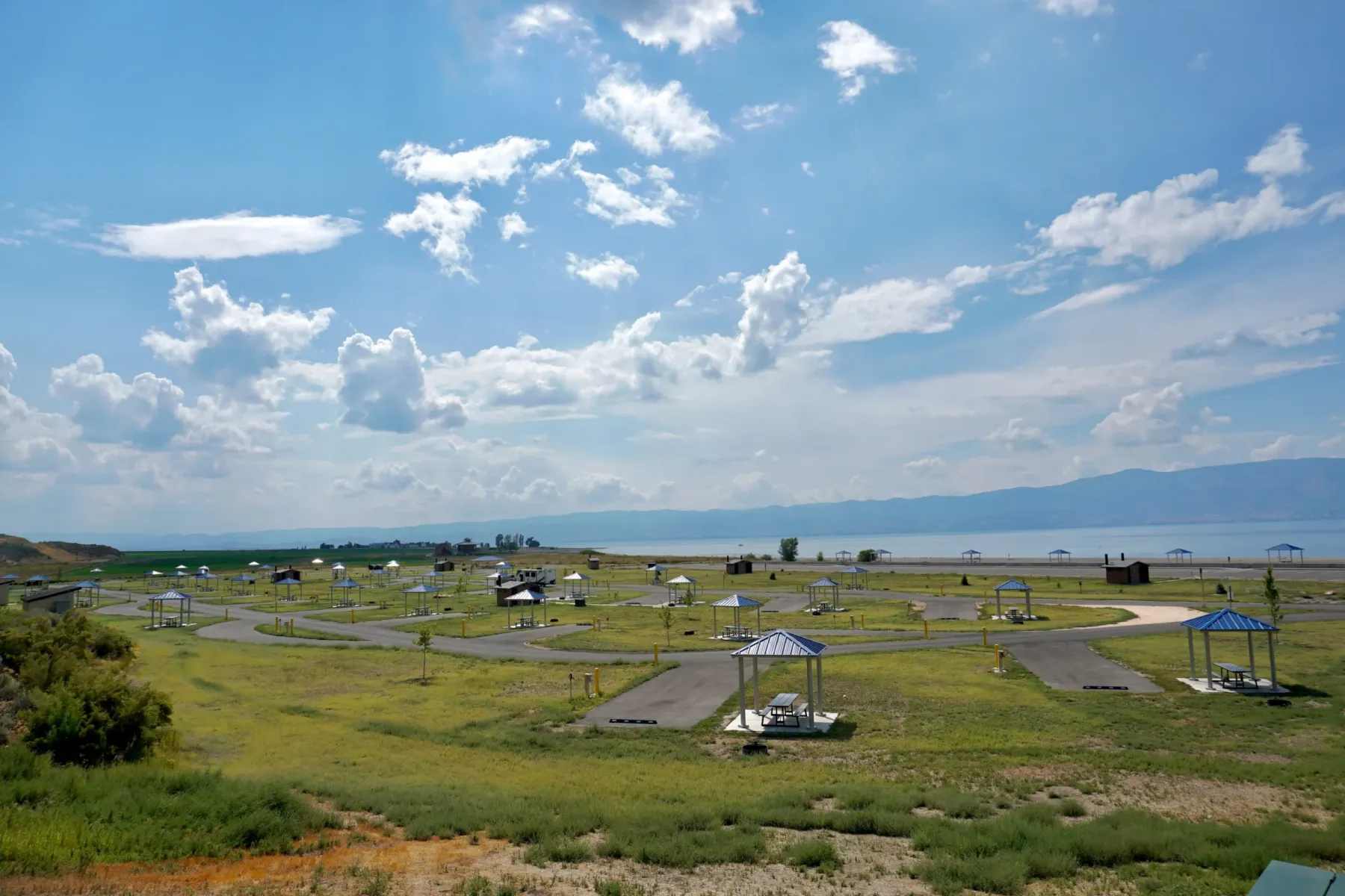 Grassy campsites with shelters and picnic tables near Bear Lake