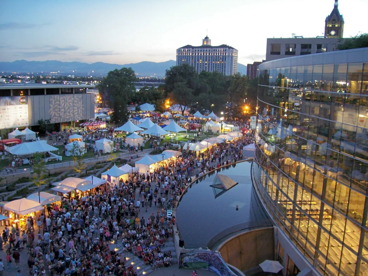 An evening crowd and festival tents at Library Square