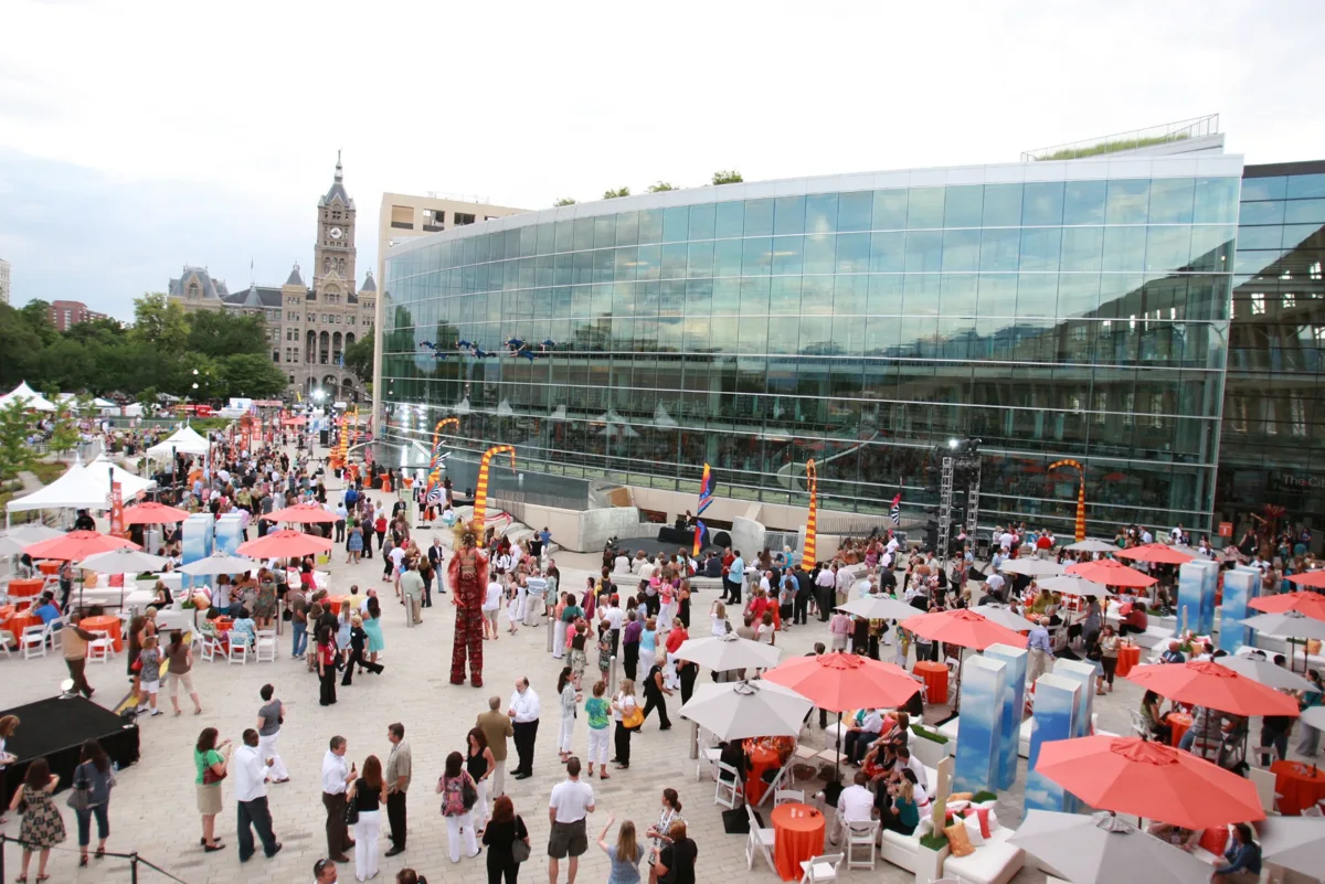 Visitors and festival tents on Library Square beside the glass-fronted City Library