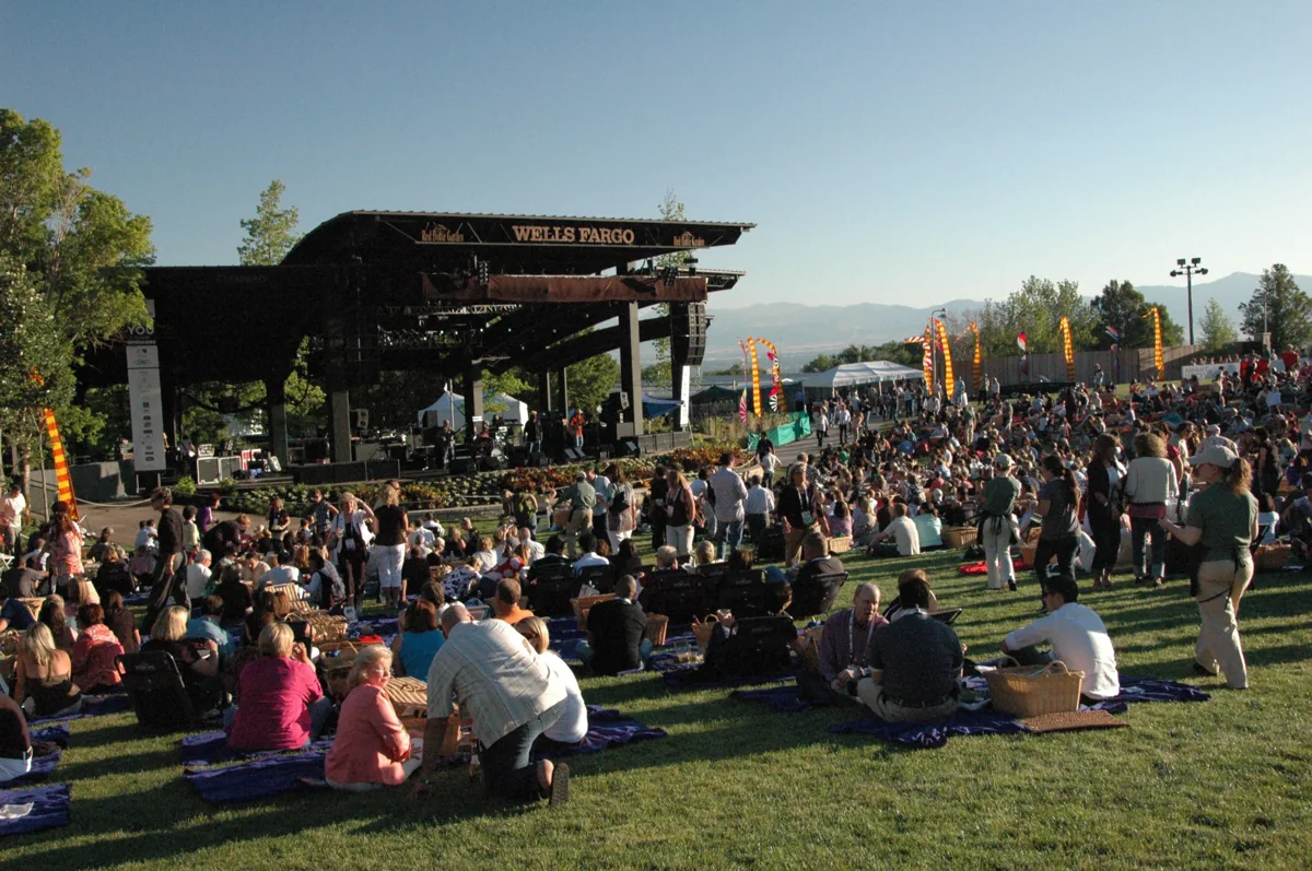 A crowd seated on the lawn in front of the Red Butte outdoor stage