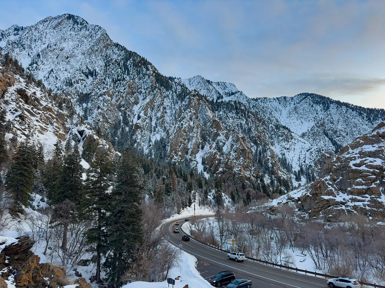 Fresh snow blanketing the evergreens and peaks of Big Cottonwood Canyon in winter