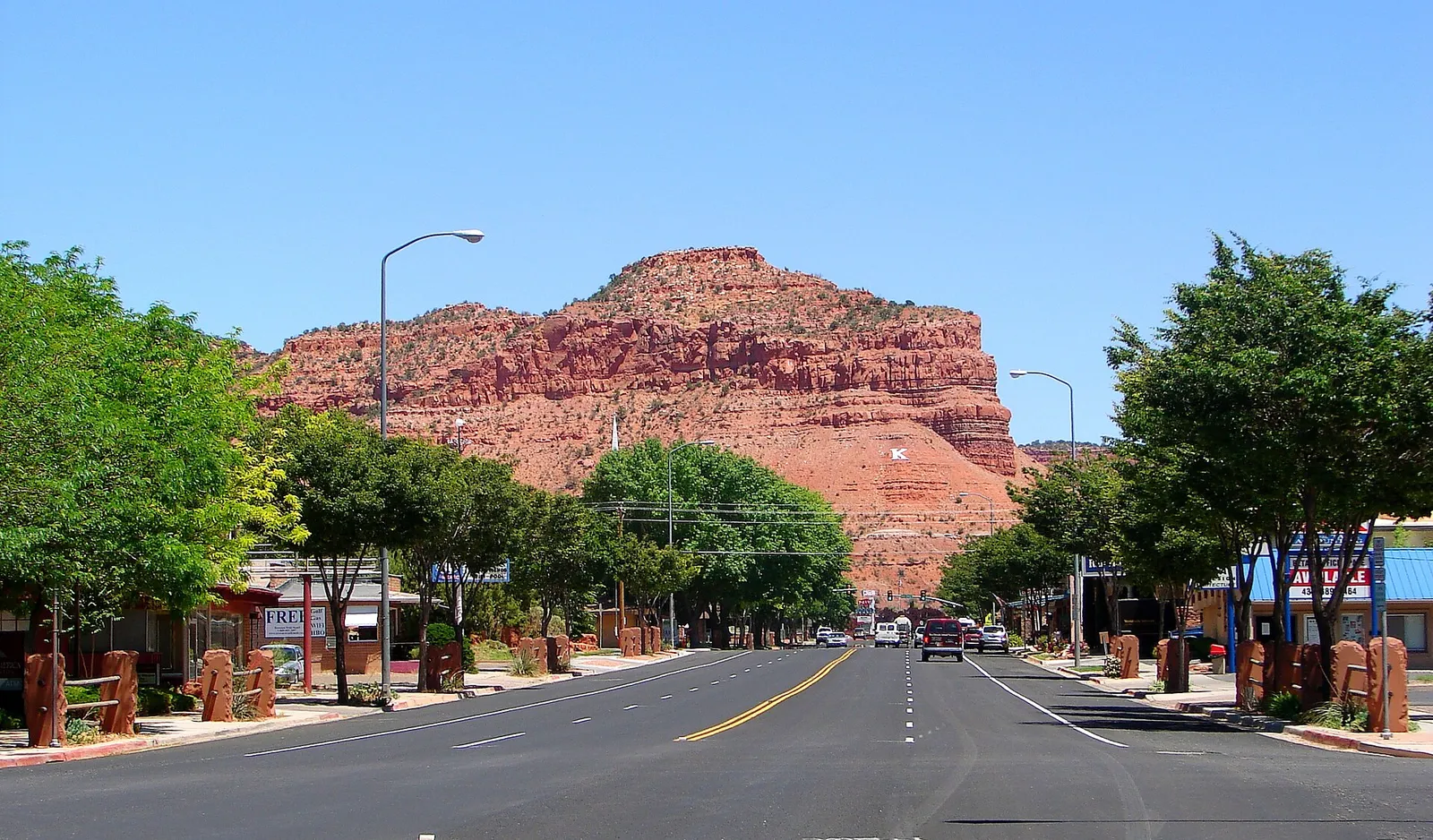 A street in Kanab beneath red sandstone cliffs