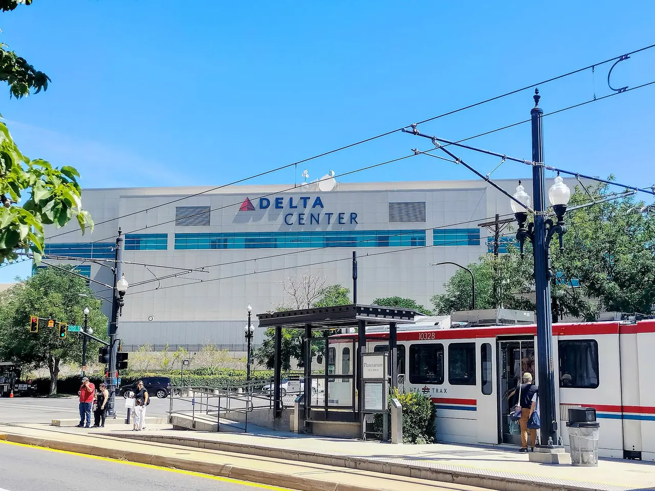 The Delta Center and a TRAX train on a downtown Salt Lake City street in August 2023