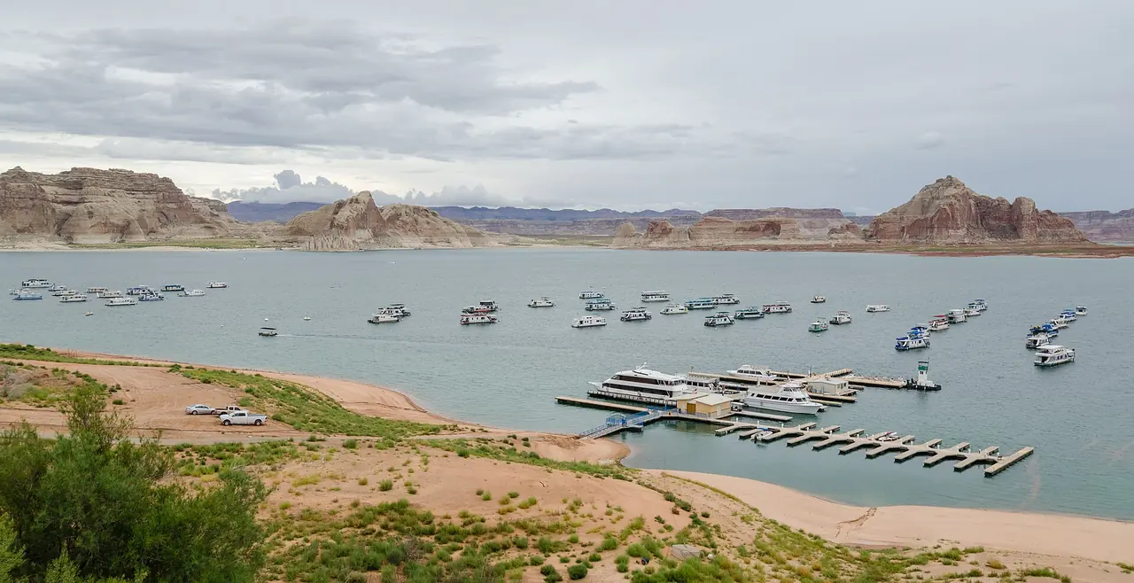 Blue water of Lake Powell among red sandstone buttes in Glen Canyon National Recreation Area